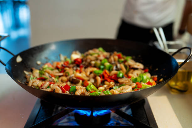 istock The chef cooks shrimps with vegetables in a wok. 2175704798