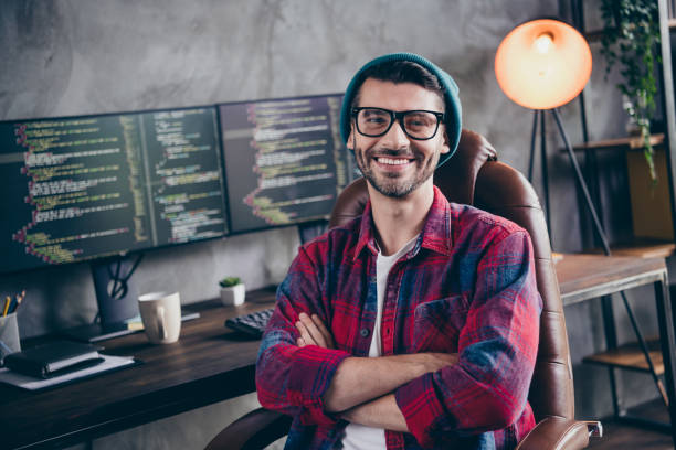 istock Photo of confident cheerful programmer wear spectacles arms folded smiling indoors workplace workshop home 2175705498