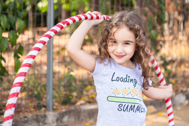 istock A girl playing with a hula hoop. 2175706332