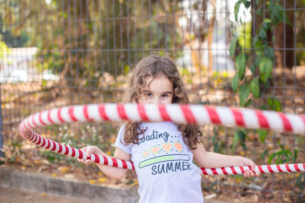 A girl playing with a hula hoop.