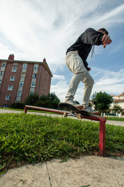 istock vertical unrecognized Skater executing a grind on a rail captured from a fish-eye view 2175710784