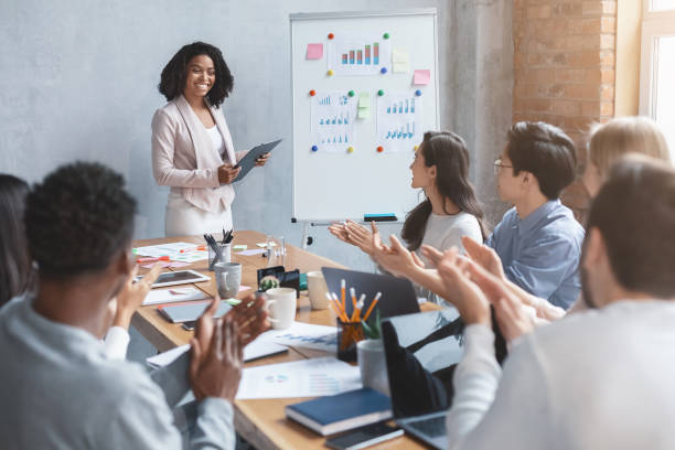 istock International business team applausing to black lady speaker 2175710871
