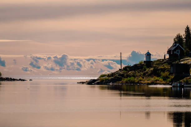 Peaceful waterscape with distant lighthouse. RATAN, SWEDEN