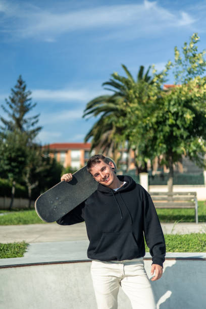 istock vertical Happy skater showcasing their skateboard with a joyful pose 2175717470