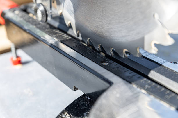 istock Miter saw tool blade up close for cutting lumber and carpentry. Using a circular saw to cut a wooden board. Blade of a miter saw to cut off the edge of a wooden board, close up. 2175718708