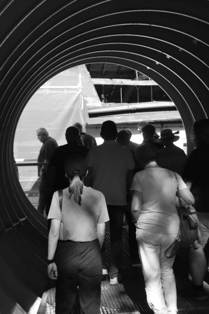 Gdansk, Poland - 09.22.2024: a group of people are walking through a spiral tunnel.