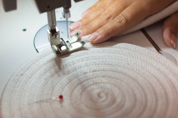 moment in Close up of sewing machine, needle and thread. Sewing process