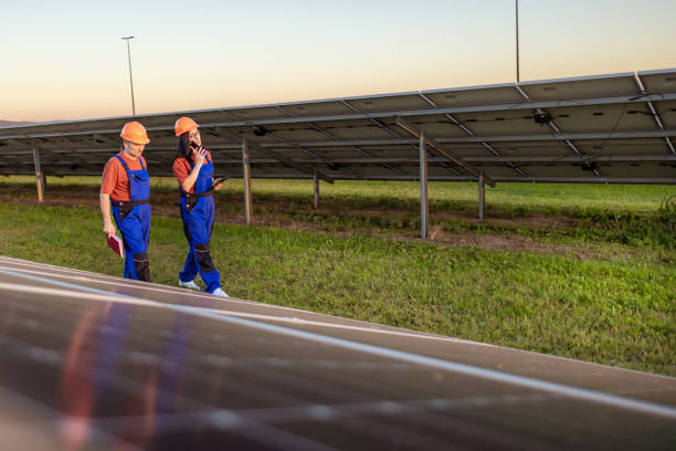 istock Two Workers Talking About Job in Solar Field 2175725215