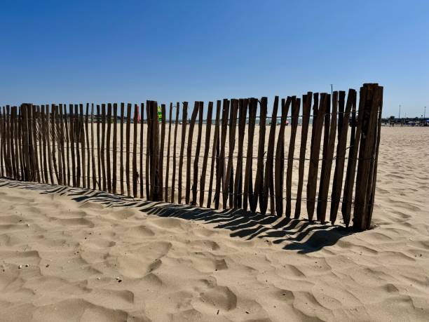 istock wooden fence on a sandy beach 2175728116