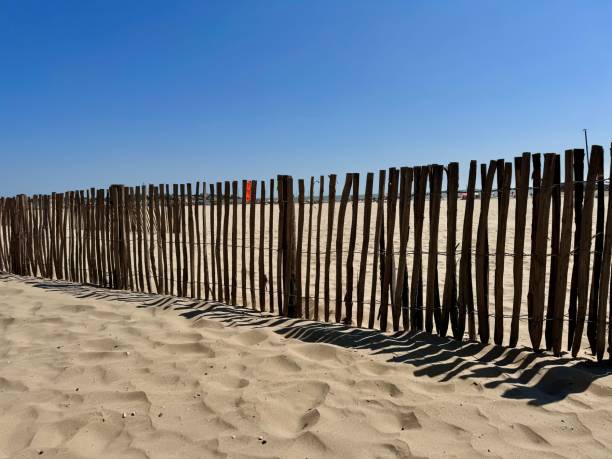 istock wooden fence on a beach 2175728137