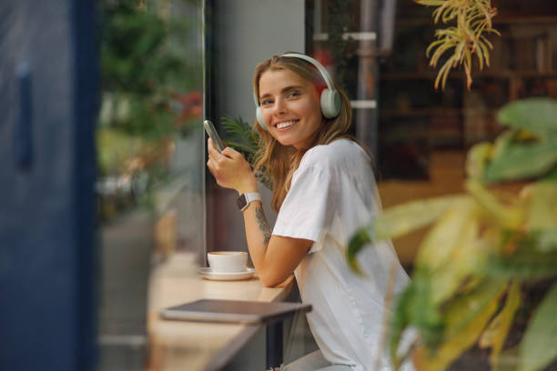 Young Woman Enjoying Music in a Cozy Caf Setting