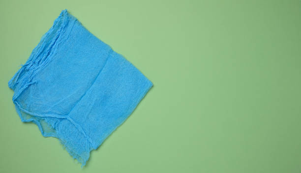 istock Folded blue kitchen towel on a green background, top view. 2175733478