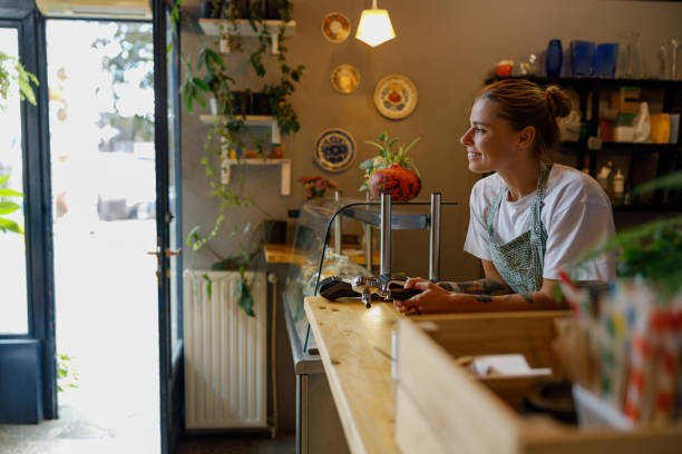 istock Cozy Caf Scene with Barista at Work in Natural Light 2175734041