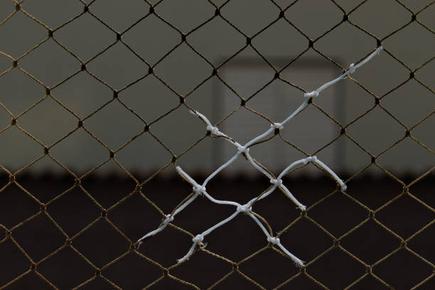 Close-Up of Rusty Wire Mesh Against Dark Background - Industrial Texture and Pattern