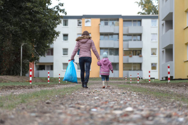 istock Mother and child collect garbage in a park 2175751391