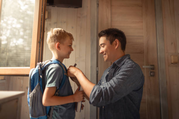 istock Young happy father getting son ready for school, father and child spending time together. family candid lifestyle. 2175757936