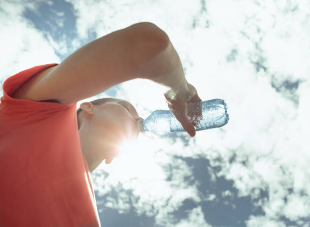 istock Thirsty woman drinking water outdoors. 2175758000