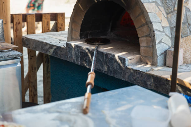 The entrance of a traditional wood-fired oven, with bread dough ready to be baked
