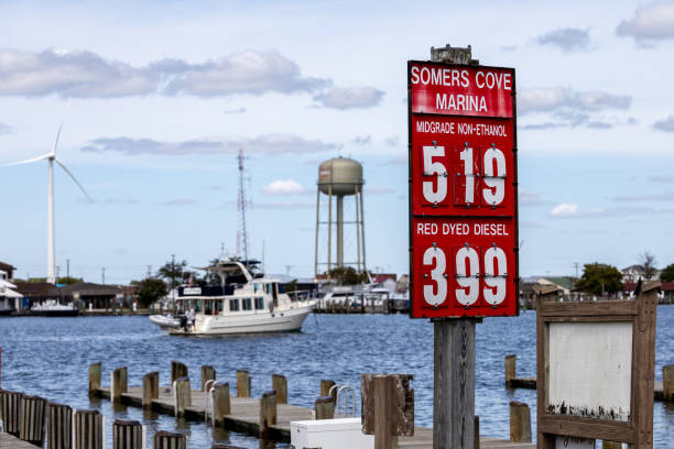 Crisfield, Maryland, USA Sept 4, 2024 A view of the port with boats, a water tower and a wind turbine and the price of fuel in the marina.