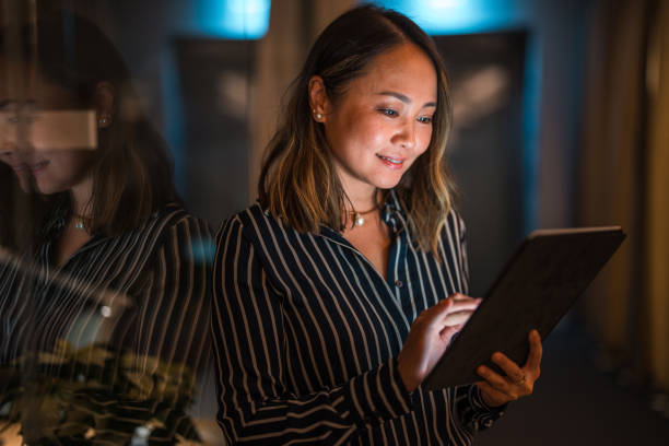 istock Asian Female Professional Working on Tablet at Night 2175768975