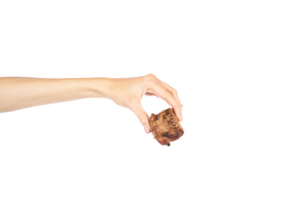 istock Grilled meat in female hand isolated on white background. 2175776658