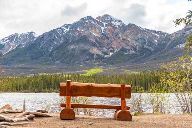 istock Incredible nature views at Pyramid Lake in Jasper National Park during spring time with bench, chair in stunning scenic area of Canada. Snow capped mountain view in background. 2175776744