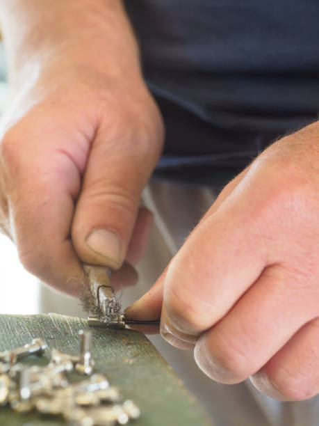 istock Craftsman cleaning metal part with wire brush 2175779355
