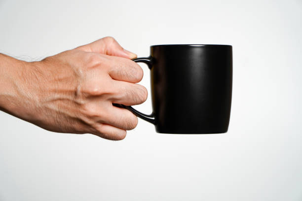istock hand holding a black cup of coffee isolated on a white background. 2175793179