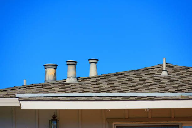 istock Several rooftop vents rise from a shingled roof under a clear blue sky. 2175796440