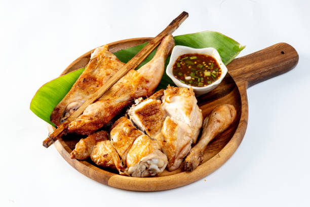 istock thai style grilled chicken (gai yang),with spicy sauce on a white background 2175801185