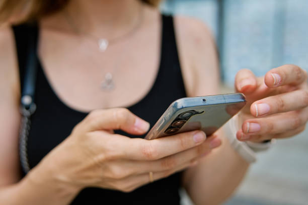 istock Woman using smartphone at city street 2175804214