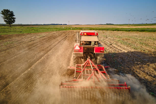 istock Tractor working in agricultural field, cultivating and plowing dry soil 2175804219