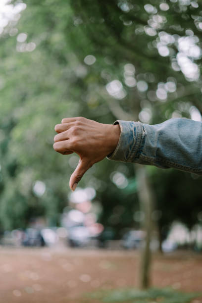 istock Hand showing an upside-down thumb gesture, conveying disapproval or a playful attitude. 2175805909