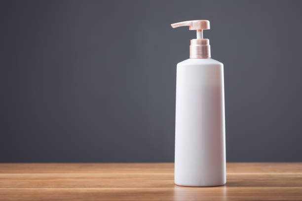 istock White shampoo bottle on a wooden table with a dark gray background, perfect for advertising minimalist beauty products 2175809072