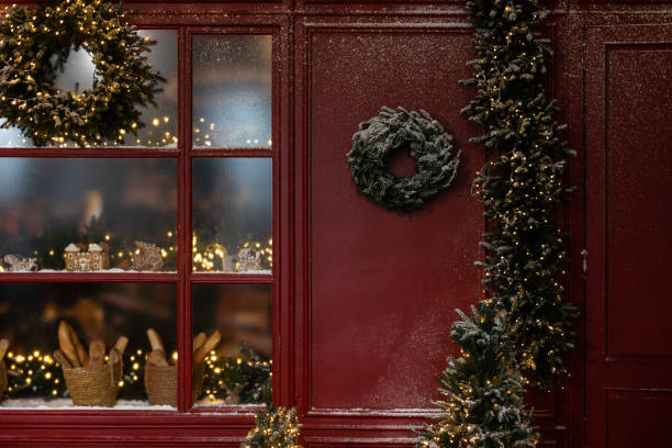 istock Christmas decor, a Christmas tree wreath on the wall, a brass candlestick with a burning candle 2175813098