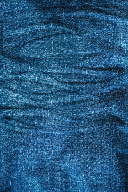 Crumpled jeans denim texture with folds background