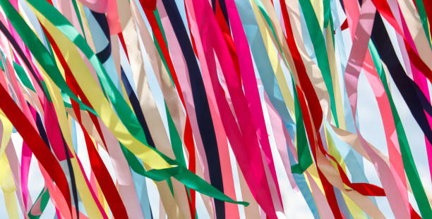 istock Multicolored festival ribbons flutter in the wind. Background 2175813594