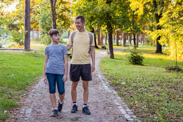 istock Connecting with nature. Father and son exploring forest in autumn and learning about plants. 2175813863
