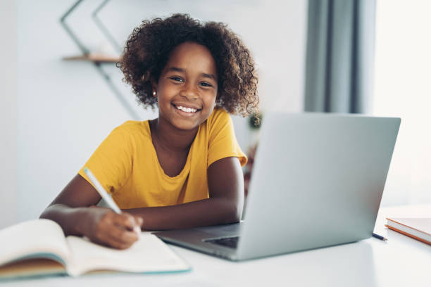 istock Smiling girl writing homework 2175813937
