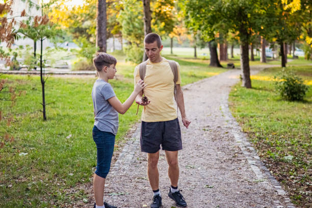 istock Connecting with nature. Father and son exploring forest in autumn and learning about plants. 2175814160