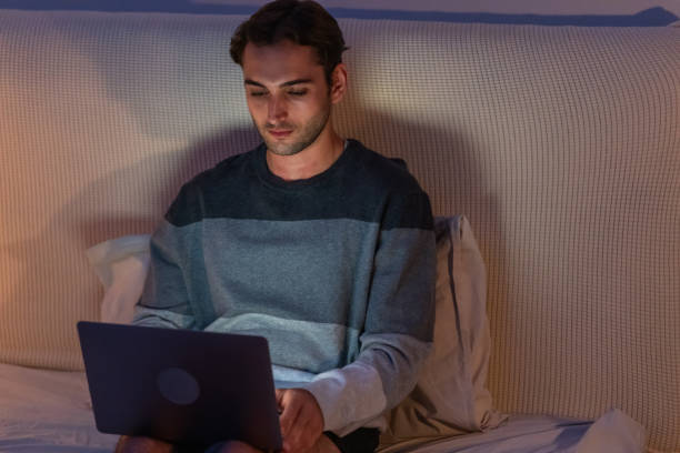 istock Young Man Working on Laptop in Cozy Room. 2175815326