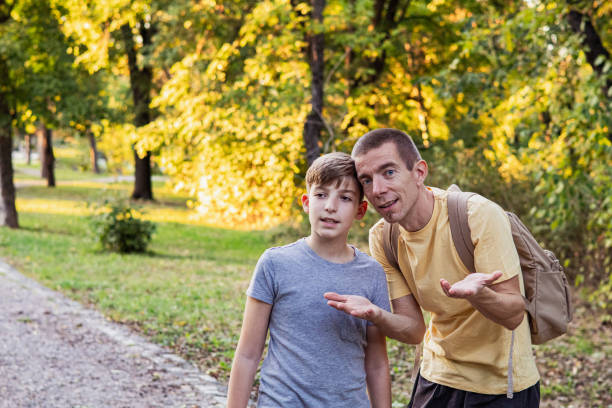 istock Connecting with nature. Father and son exploring forest in autumn and learning about plants. 2175815703