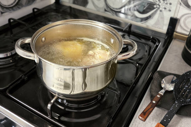 istock Chicken broth is cooked in a metal pot in a home kitchen. 2175816509