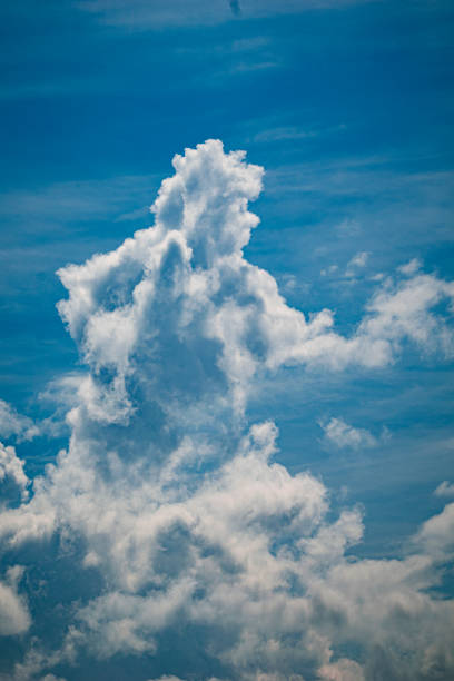 a cloud with resemblances of a man on a horse with a gun