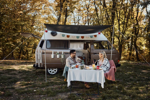 istock Happy couple talking on picnic at trailer park. 2175818467