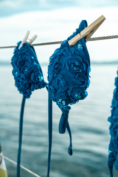 Swimwear hanging on a sailboat.