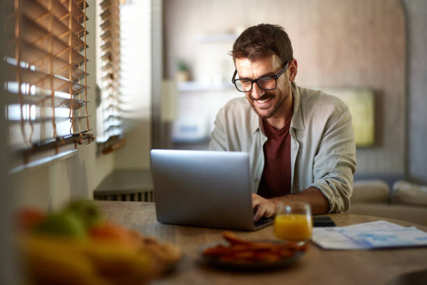 istock Happy man working on laptop at home. 2175821259