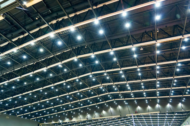 Scattered dot directional led lights on rails under the ceiling in a modern large public space warehouse, shopping center building, office or other commercial real estate object.