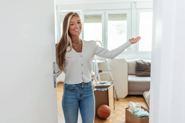 istock Young woman presenting her new house. 2175823924