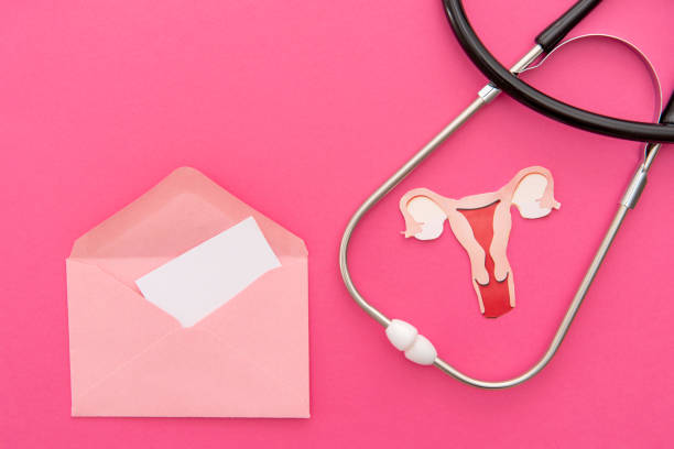 istock Stethoscope and Uterus Paper Cutout with Blank Note in envelope on Pink Background 2175826445